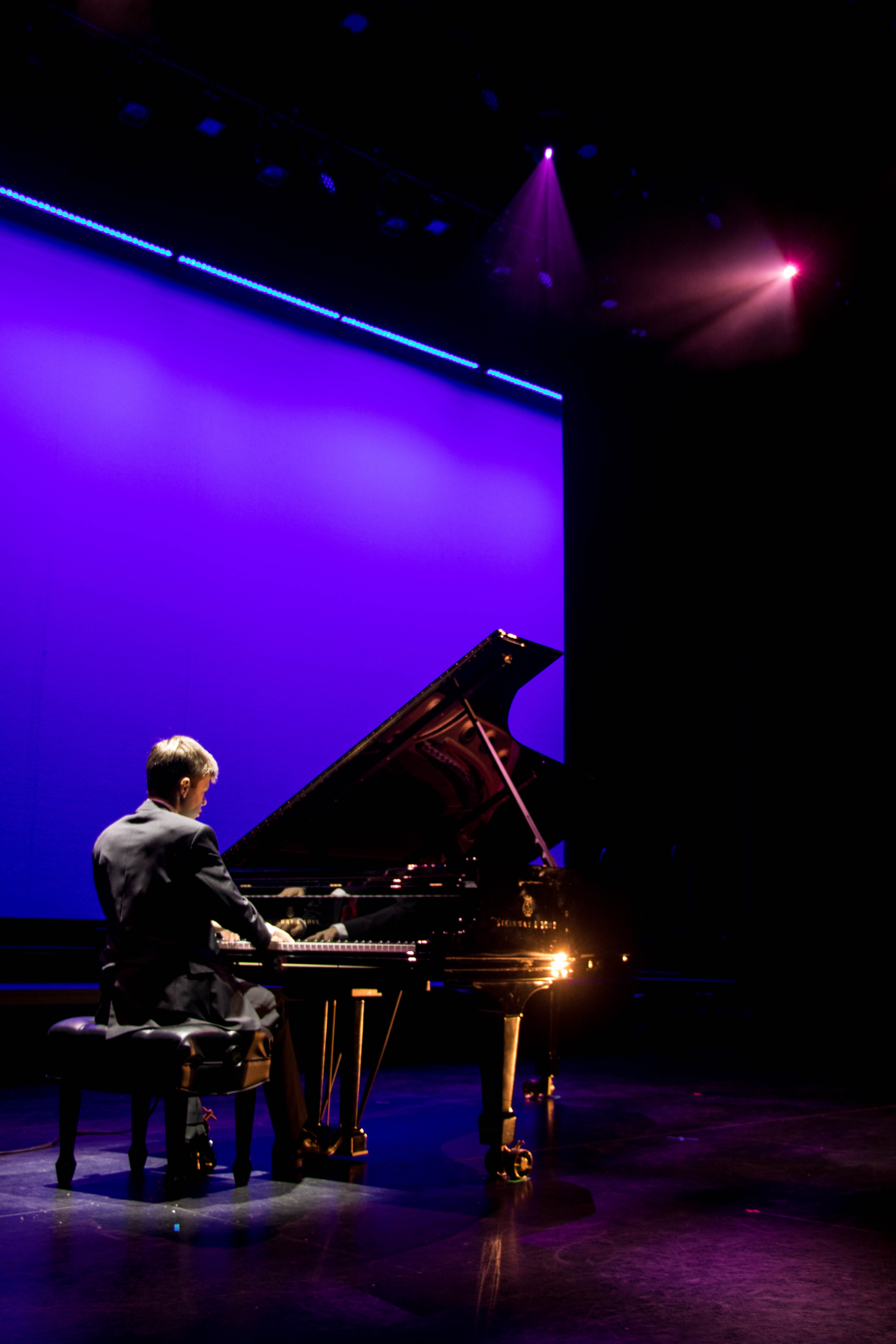 Michael Rainwater performing at Tower of Talent 2019 with blue stage lighting